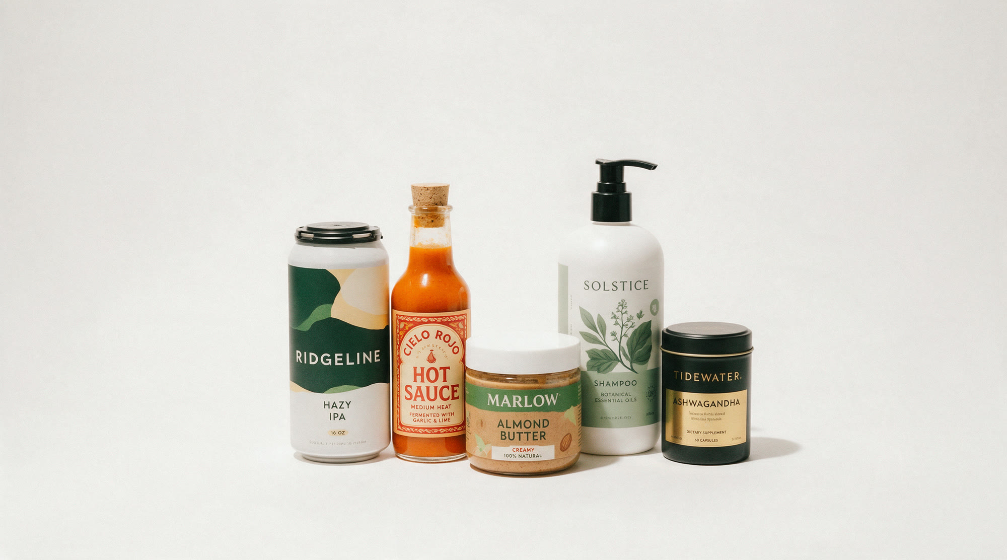 Five retail products: a Ridgeline hazy IPA can, a Cielo Rojo hot sauce bottle, a Marlow almond butter jar, a Solstice shampoo bottle and a Tidewater supplement tin